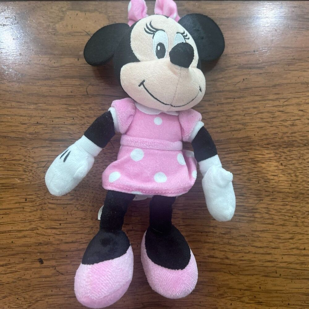 Minnie Mouse Disney Jr Plush in a pink dress with white polka dots.